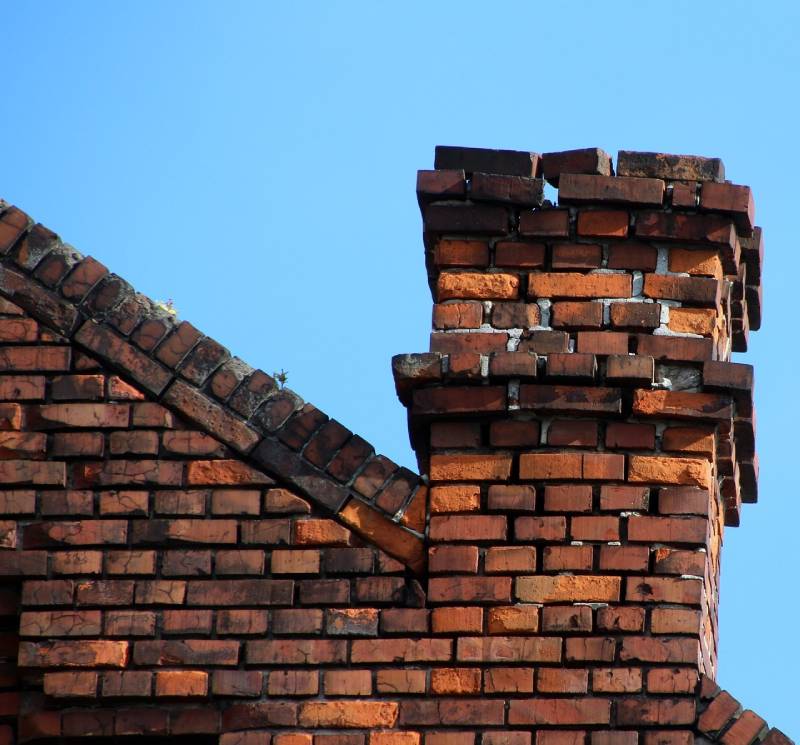 Damaged chimney on an Upper Marlboro home showing cracks and missing mortar